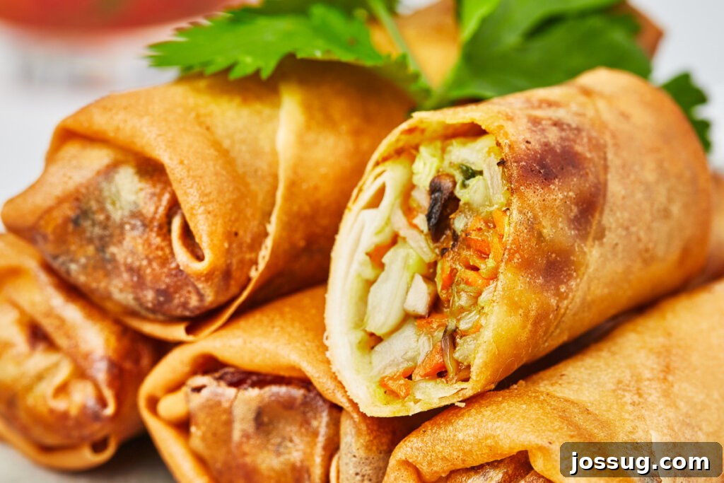 Air-fried spring roll cut in half, showcasing the vibrant vegetable filling