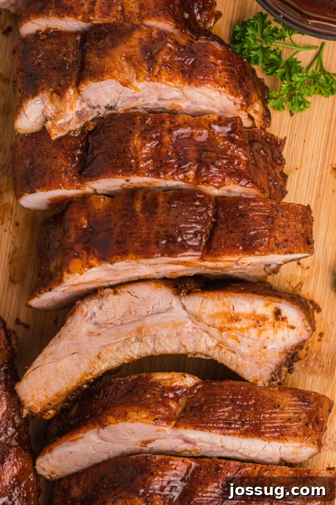 Mouthwatering Oven Ribs 2 oven baked ribs cut into pieces on wooden cutting board