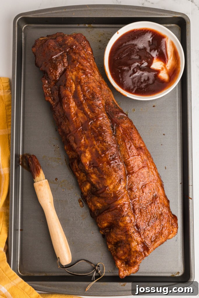 Mouthwatering Oven Ribs 3 finished rack of ribs on a baking sheet