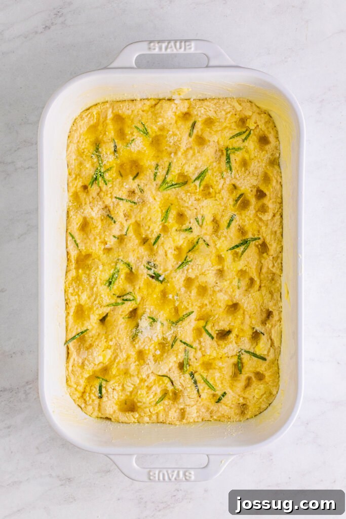 unbaked rosemary focaccia in pan