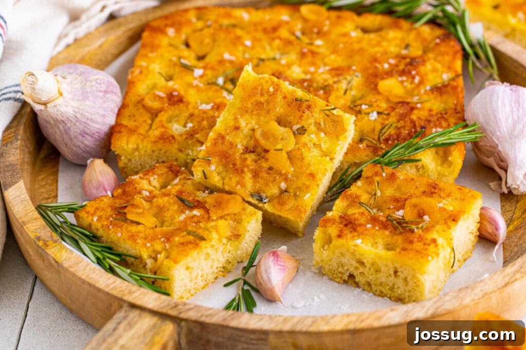 pieces of rosemary focaccia bread in wooden serving tray