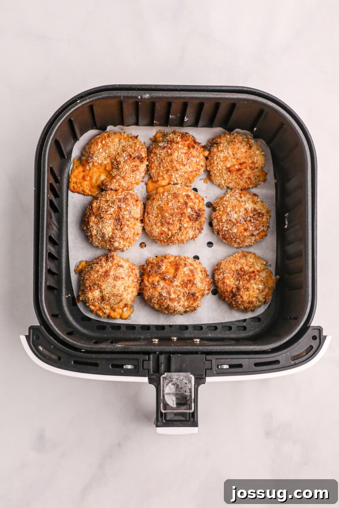 A basket full of golden-brown air fryer buffalo chicken poppers, freshly cooked and ready to be served.
