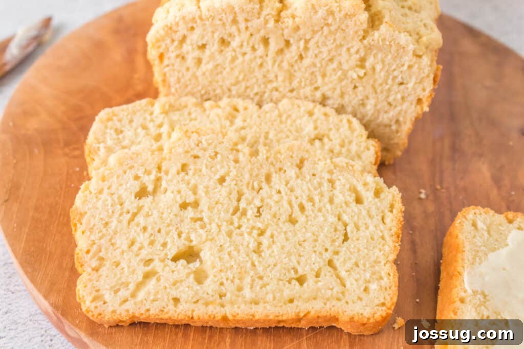 No-Knead Beer Bread 6 A close-up image of a perfectly baked slice of Beer Quick Bread on its side, showing the tender crumb and light golden crust.