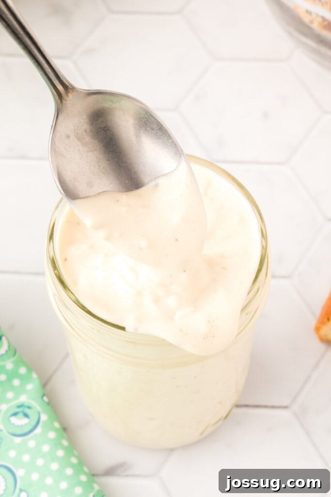 Caesar Salad Reinvented 3 Spoon scooping dressing out of jar