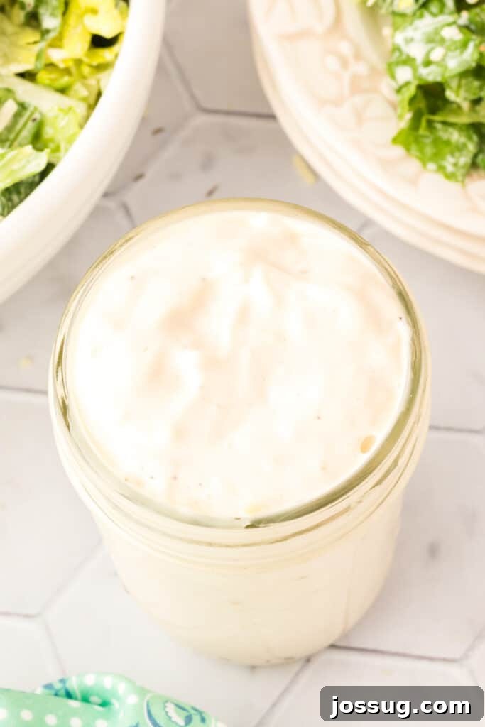 Caesar Salad Reinvented 4 Closeup looking down into a jar filled with Caesar salad dressing