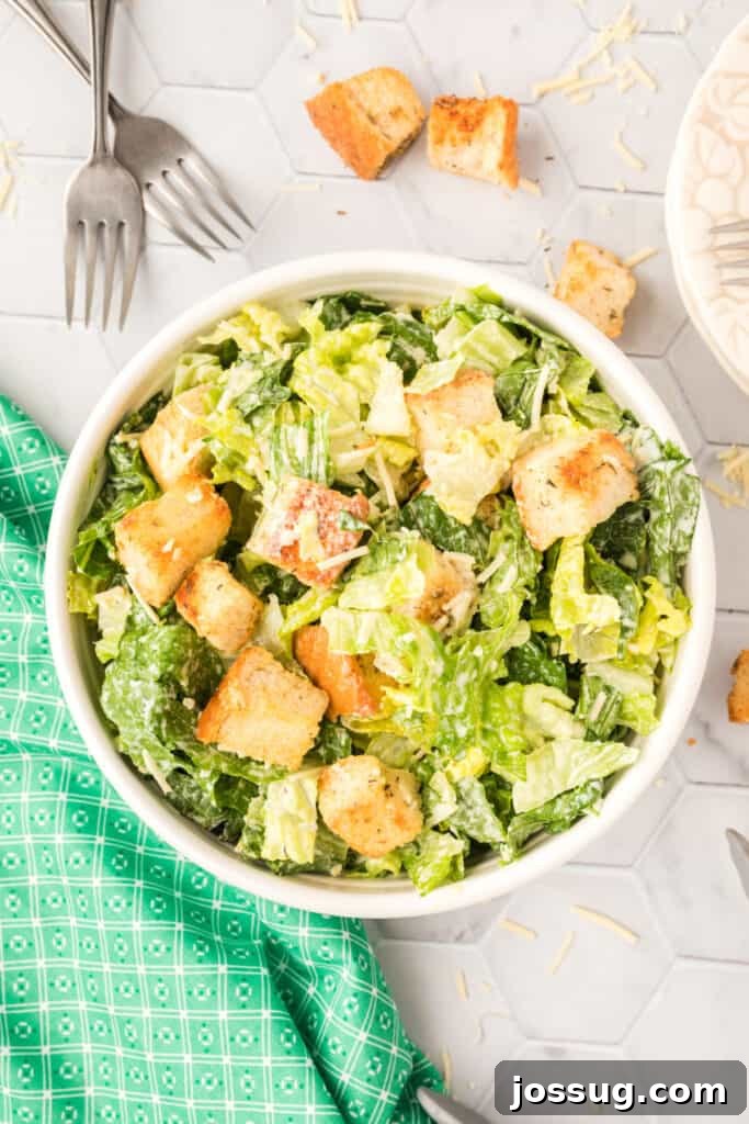 The Emperor's Salad 2 caesar salad in white bowl, a close-up shot showcasing the crisp lettuce and dressing