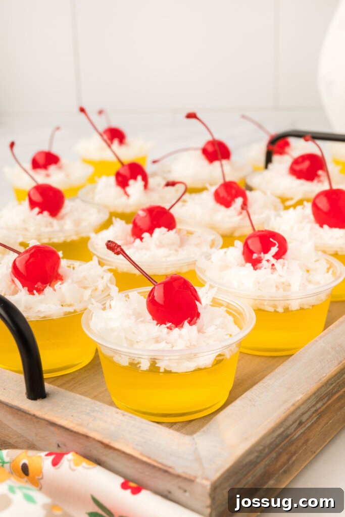 Paradise Piña Jiggle Shots 2 pina colada jello shots on a wooden serving tray