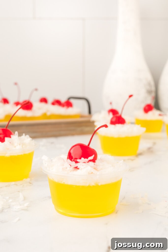 Paradise Piña Jiggle Shots 3 gelatin shots on a marble-topped table