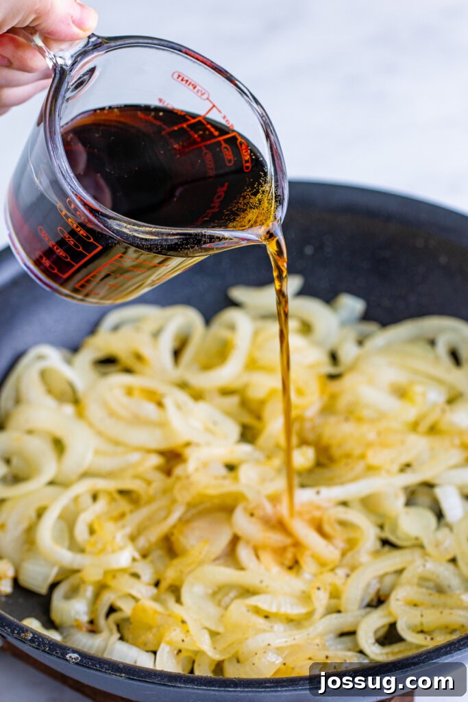 Coke-Kissed Caramelized Onions 4 Coca-Cola being poured into a skillet with browning onions