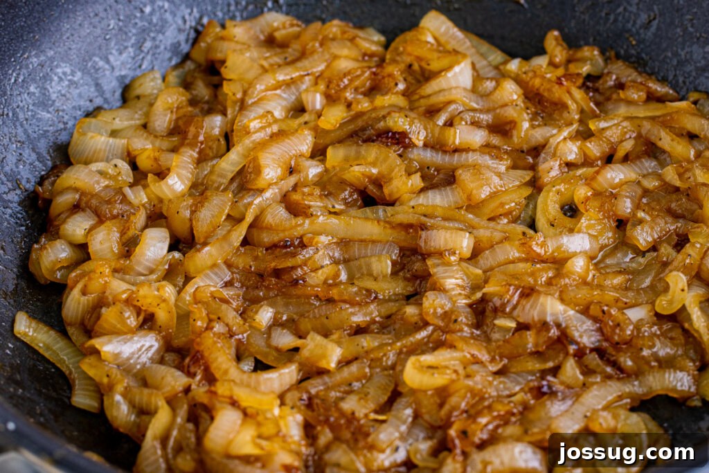 Coke-Kissed Caramelized Onions 6 Close-up of Coca-Cola caramelized onions in a skillet, rich and glossy