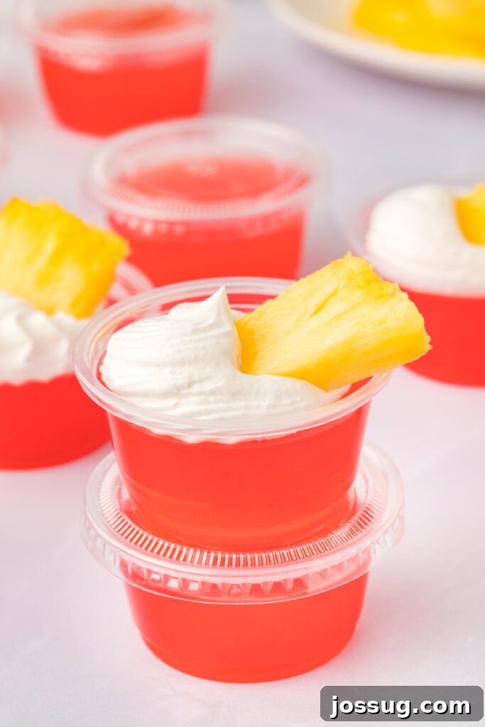 Caribbean Rum Jelly Shooters 2 Two vibrant rum punch jello shots, perfectly stacked and ready to enjoy, showcasing their inviting tropical colors.