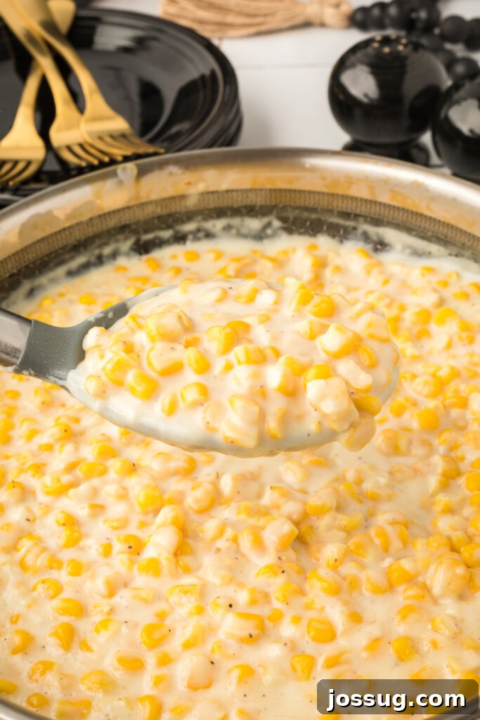 creamed corn scooped out of pan onto a serving spoon