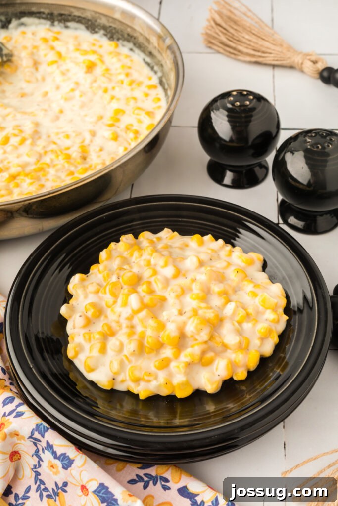 a serving of creamed corn on a black plate