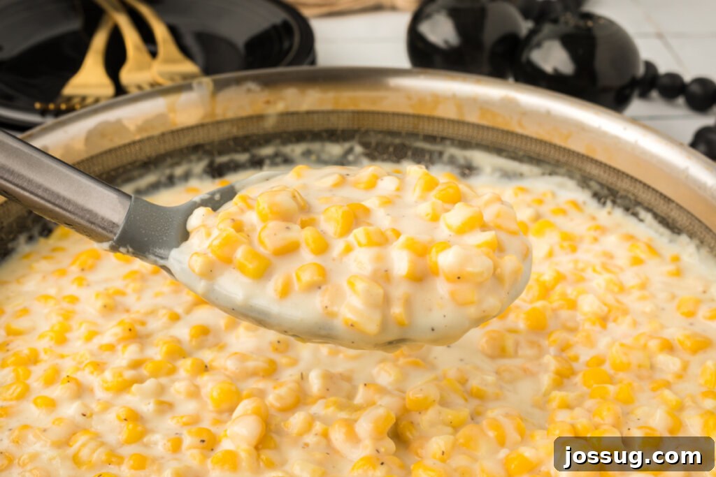 creamed corn on serving spoon over skilelt