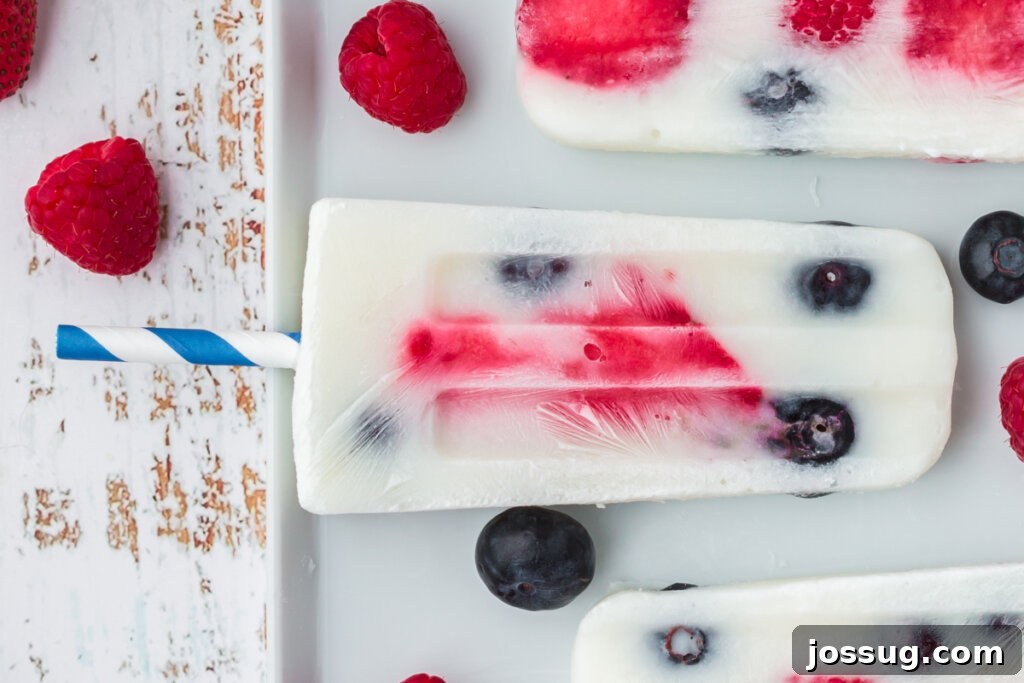 Red White and Blue Berry Pops 6 patriotic berry popsicle laying on a white plate