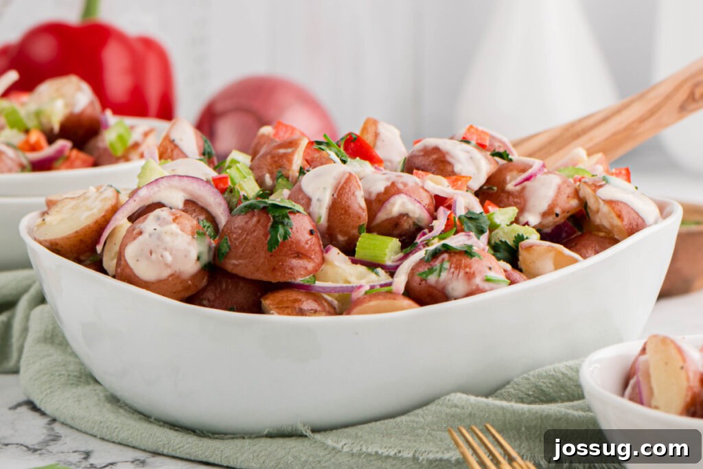 Large white serving bowl filled with homemade Red Skinned Potato Salad, seen from above