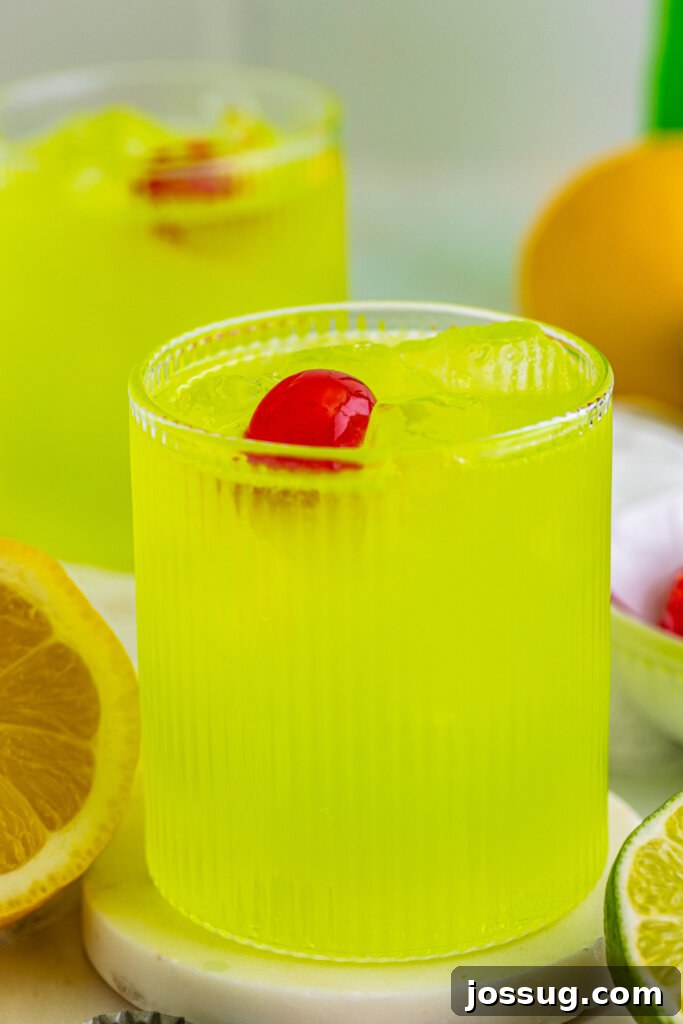 Midori Sour cocktail on coaster on table