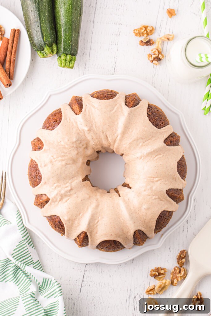 Garden Green Bundt Delight 3 Overhead view of a perfectly baked Zucchini Bundt Cake, glistening with a cinnamon sugar glaze, ready for serving.