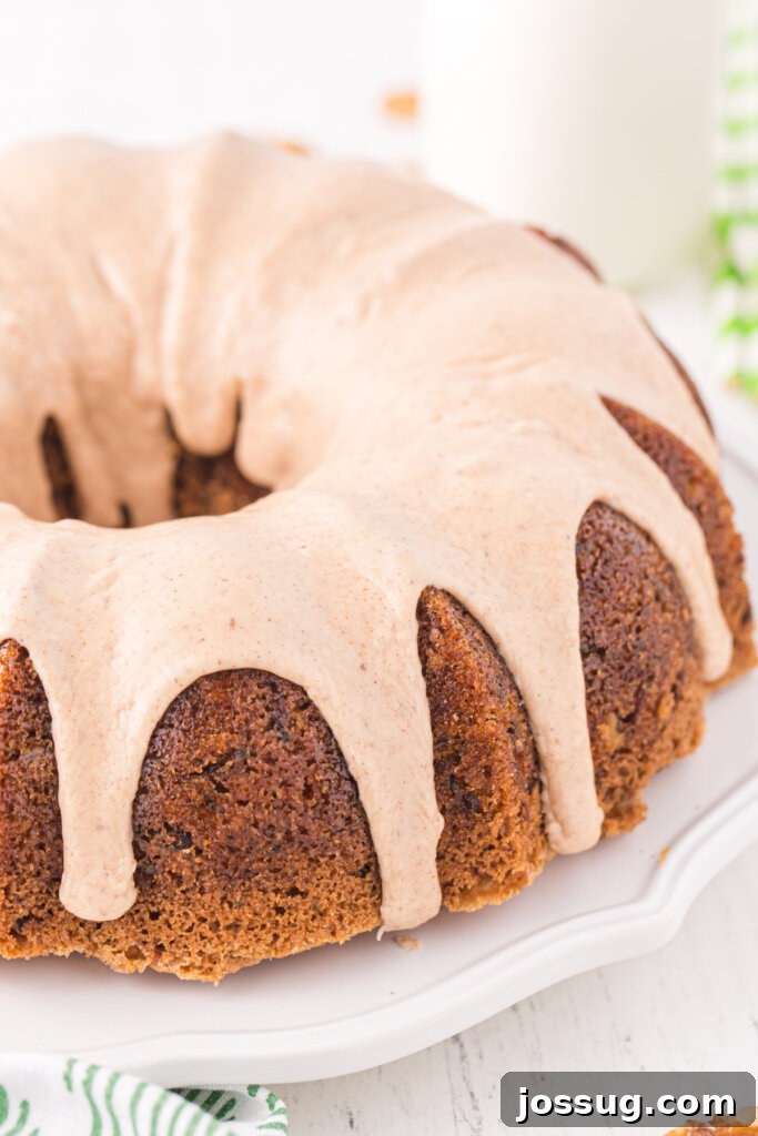 Garden Green Bundt Delight 4 Whole Zucchini Bundt Cake generously drizzled with cinnamon icing, presented on an elegant serving platter.