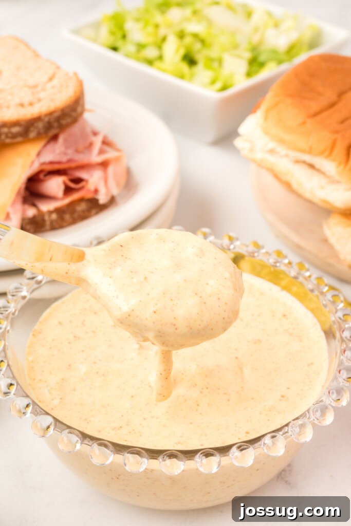 copycat big mac sauce pouring off a spoon into a bowl
