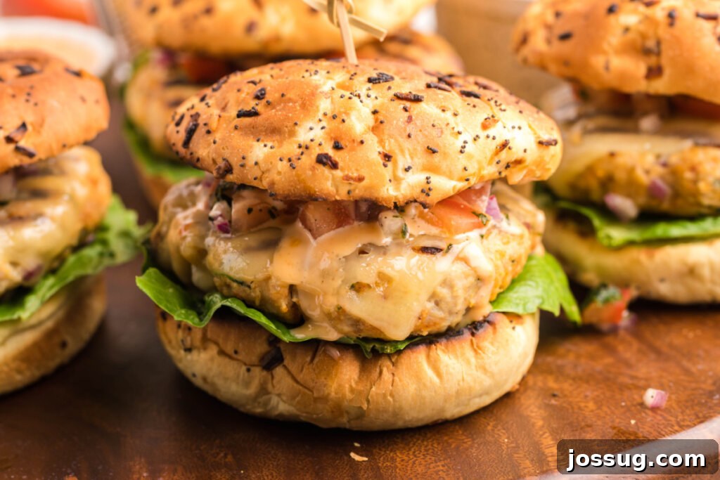 Explosive Bang-Bang Chicken Burgers 7 Delicious chicken burgers arranged on a cutting board, garnished with fresh herbs, ready to be served.
