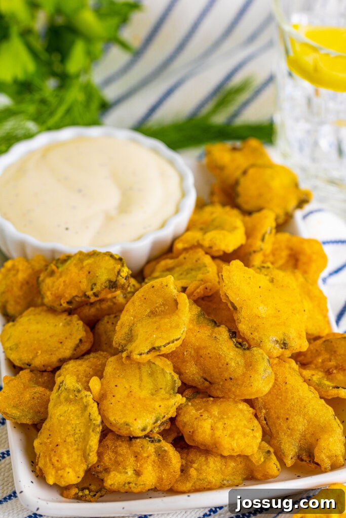 fried pickles with dipping sauce on serving platter