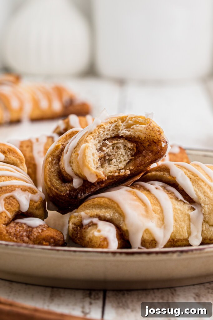 Sweet Cinnamon Crescents 5 closeup of golden brown cinnamon crescent rolls with a white glaze drizzle