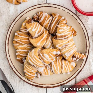 finished cinnamon crescent rolls on plate, glazed