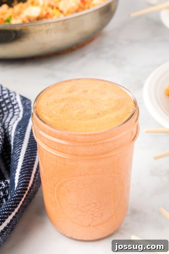 Irresistible Dipping Sauce 2 Glass jar filled with homemade Yum Yum Sauce, ready for serving or storage, showcasing its creamy, light orange color.