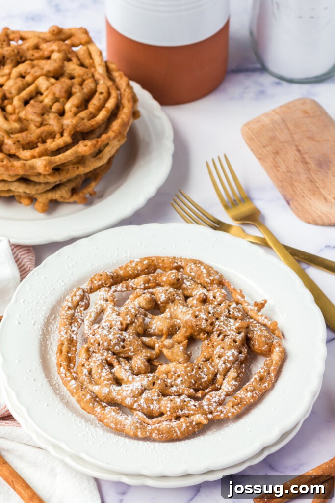 Autumn Spice Swirl Cakes 2 A beautifully plated Pumpkin Spice Funnel Cake, dusted with powdered sugar, ready to be enjoyed.