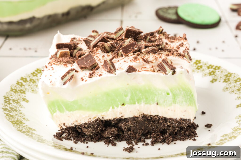 Layers of Luxe: Grasshopper Lasagna 6 A beautiful single slice of Grasshopper Lasagna Lush presented on a small white plate, ready to be enjoyed.
