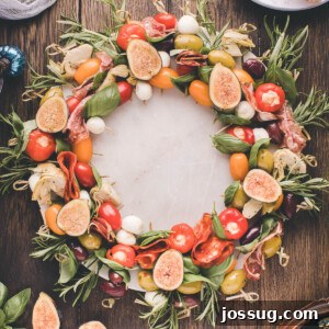 Gourmet Grazing Wreath 12 A beautifully arranged Antipasto Wreath, vibrant with colorful ingredients like cured meats, cheeses, olives, and fresh herbs, displayed on a dark table, ready to be enjoyed at a festive gathering.