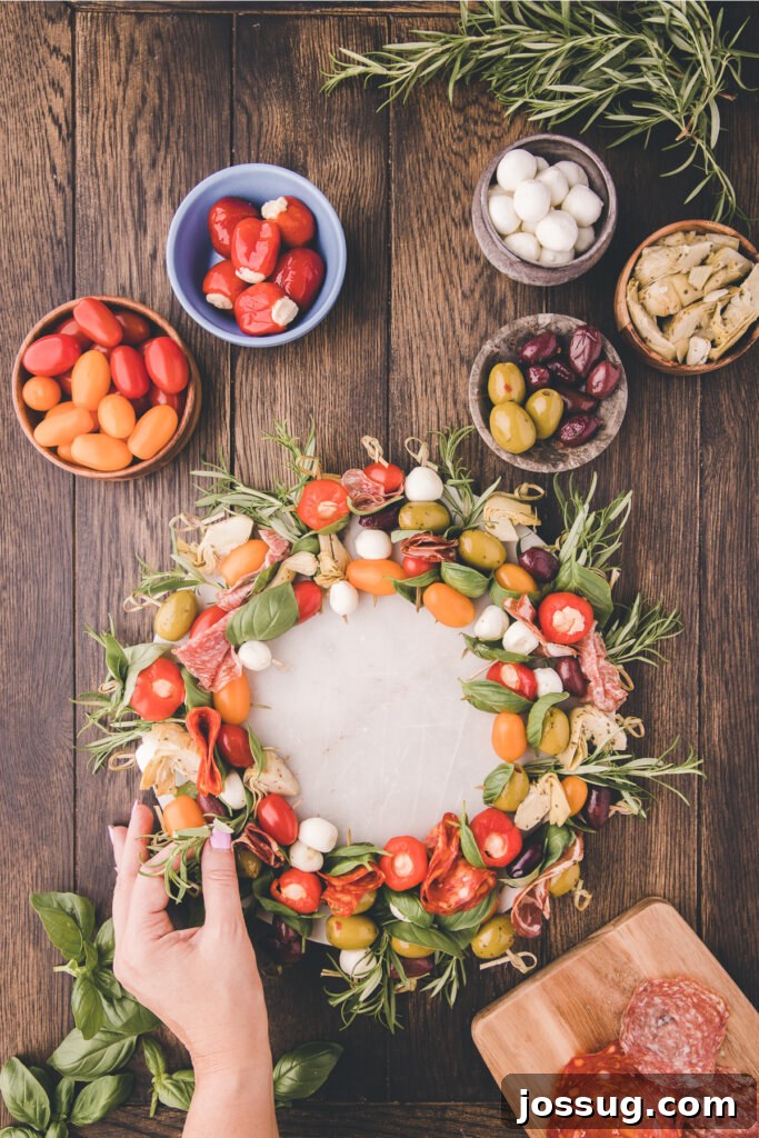 Gourmet Grazing Wreath 6 Fresh, aromatic sprigs of dark green rosemary are delicately nestled and interspersed between the colorful antipasto skewers, enhancing the wreath's natural, festive aesthetic and adding a wonderful, invigorating fragrance.