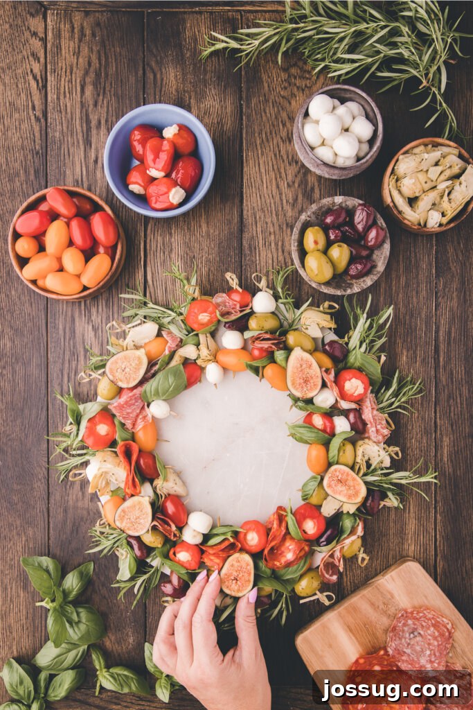 Gourmet Grazing Wreath 7 Delicately halved fresh figs are strategically placed on top of the vibrant antipasto skewers, contributing a touch of sophisticated sweetness, a unique texture, and an elegant finish to the festive wreath.