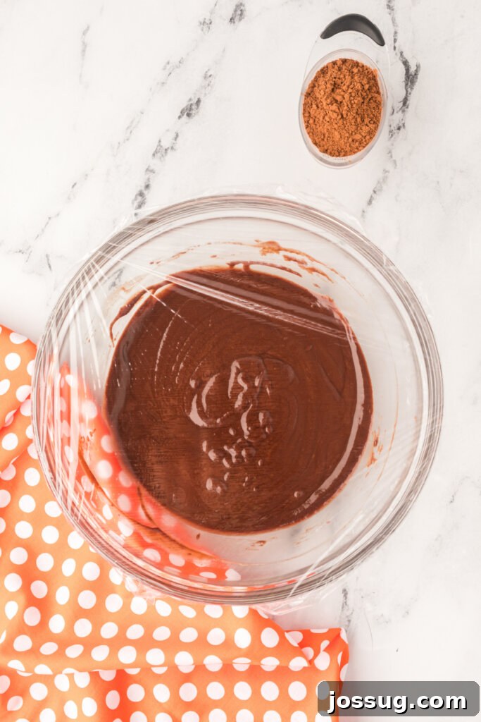 Chocolate ganache covered with plastic wrap, ready for refrigeration