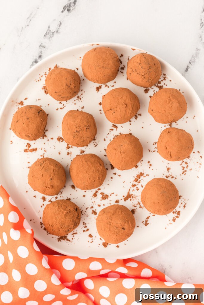 Finished chocolate orange truffles on a plate, ready to be chilled before serving
