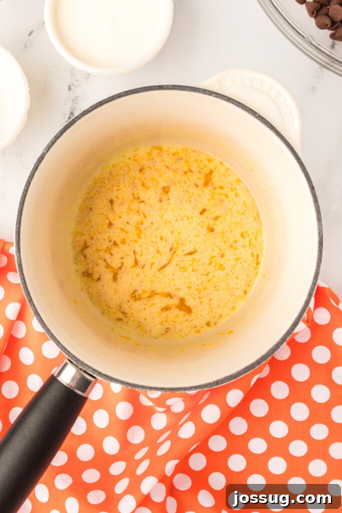 Melted butter mixture with orange zest in a saucepan