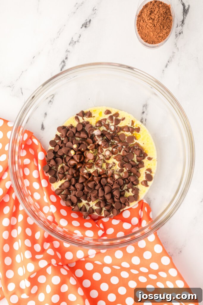 Orange extract being added to the chocolate and cream mixture
