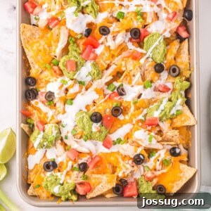closeup of chicken nachos on sheet pan
