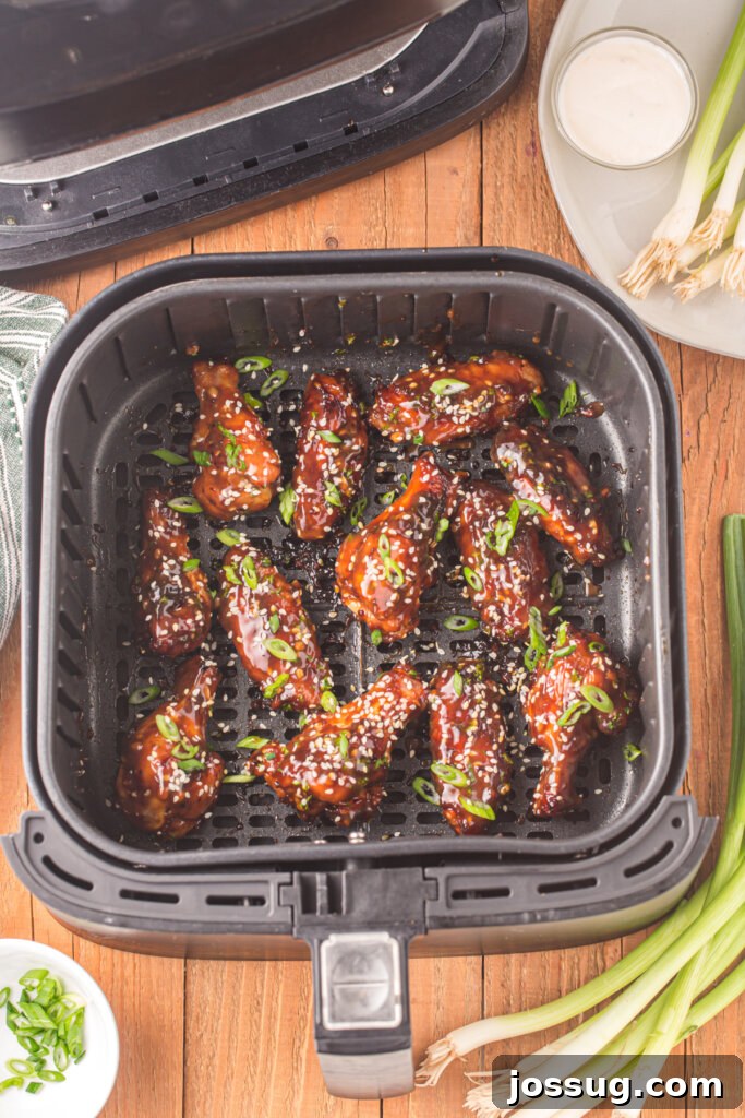 Crispy Sticky Teriyaki Air Fryer Wings 3 air fryer basket with teriyaki chicken wings in it