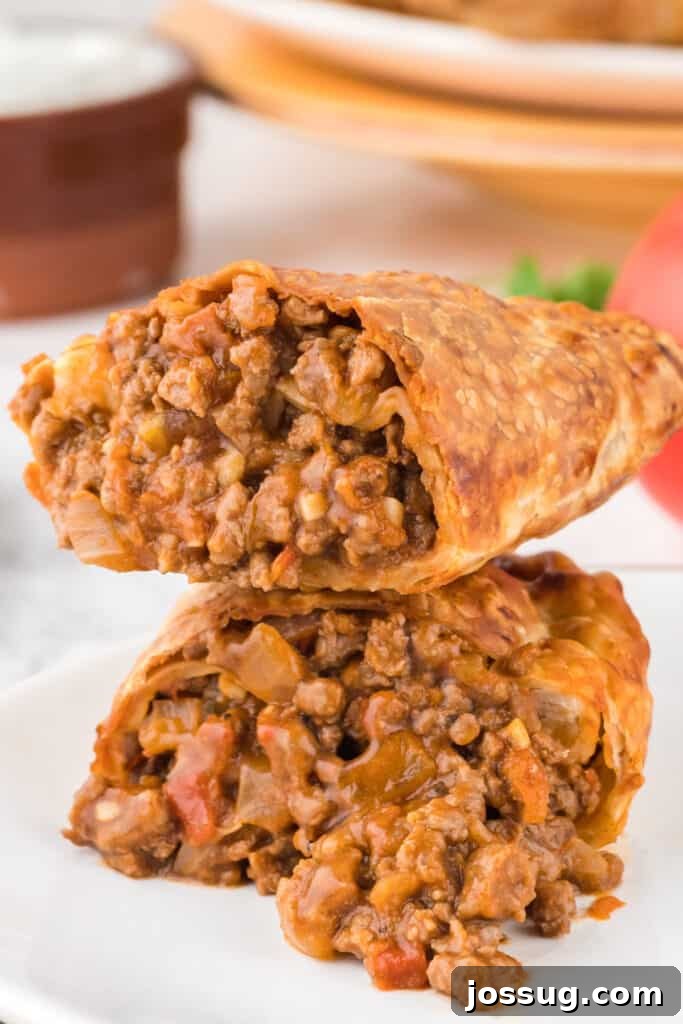 Crispy Air-Fried Beef Empanadas 2 Crispy Air Fryer Beef Empanada split in half to reveal the savory beef filling