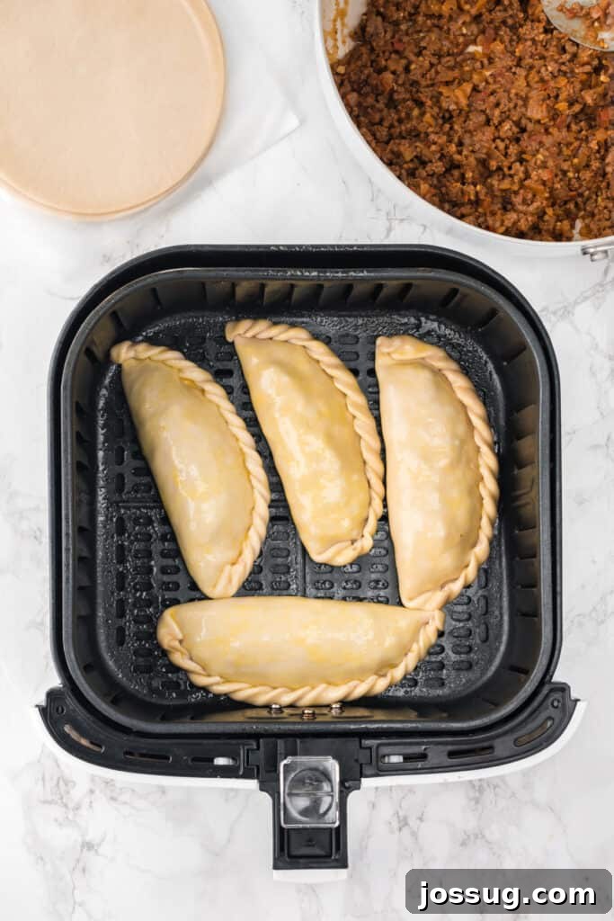Crispy Air-Fried Beef Empanadas 11 Place the empanadas in the air fryer basket in a single layer, making sure they are not touching.