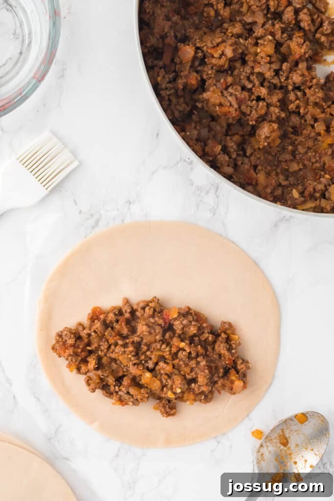 Crispy Air-Fried Beef Empanadas 8 Preheat the air fryer to 350°F (190°C). Lay out the empanada discs on a clean surface. Place 2-3 tablespoons of the beef mixture in the center of each disc.
