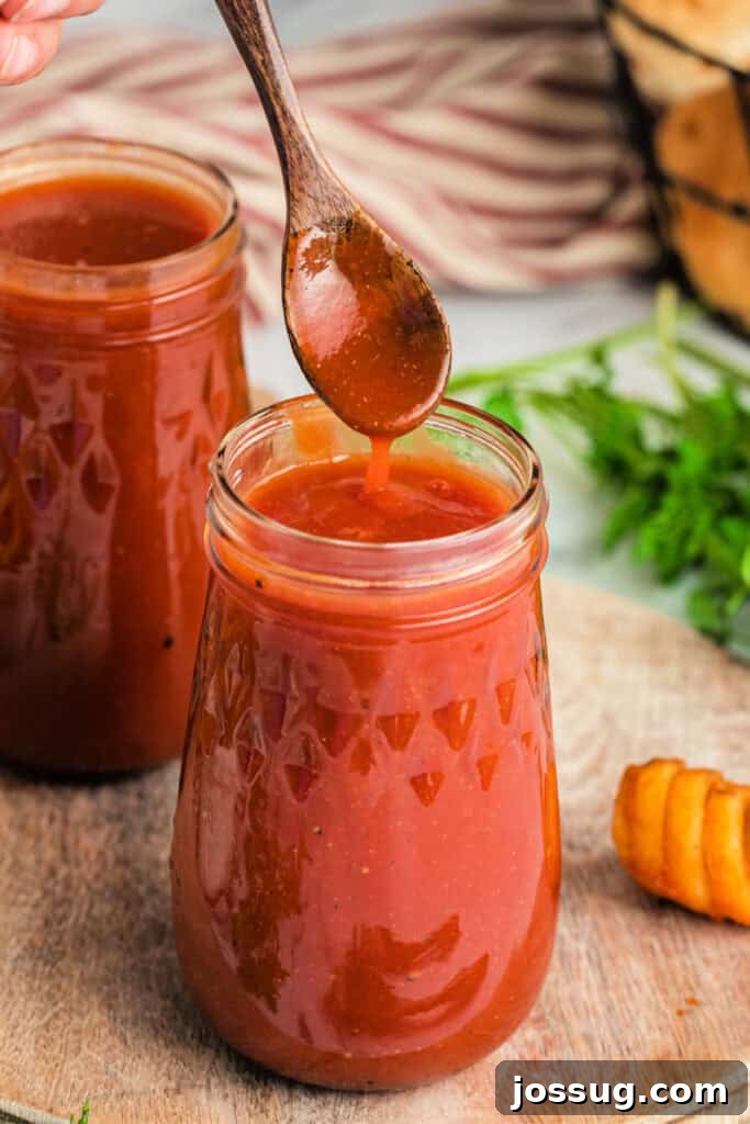 Homemade Arby's Sauce 2 copycat arby's sauce on spoon over glass jar holding sauce