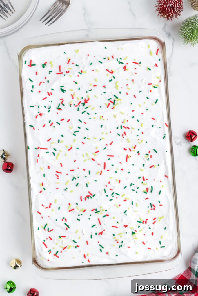 Festive Surprise Poke Cake 11 sprinkles on the cake