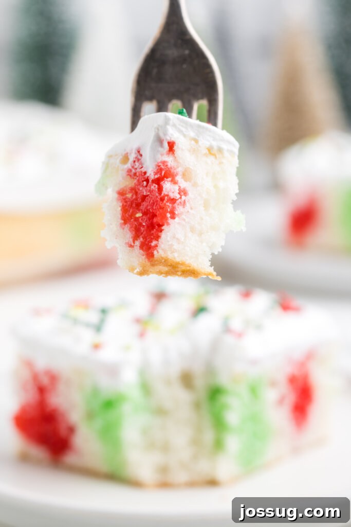 Festive Surprise Poke Cake 13 bite of christmas poke cake on fork