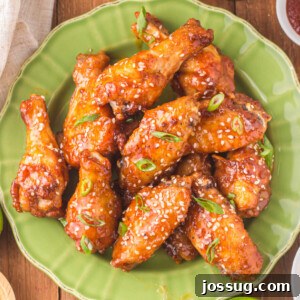 closeup of honey sriracha wings on green plate