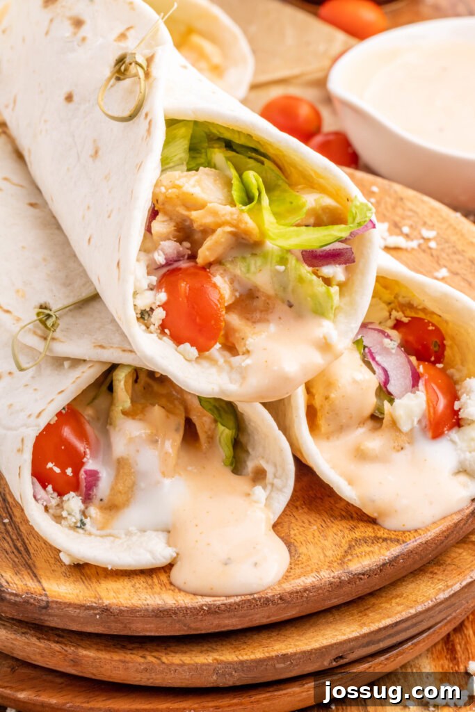 Spicy Buffalo Chicken Roll-Ups 2 three buffalo chicken wraps on cutting board