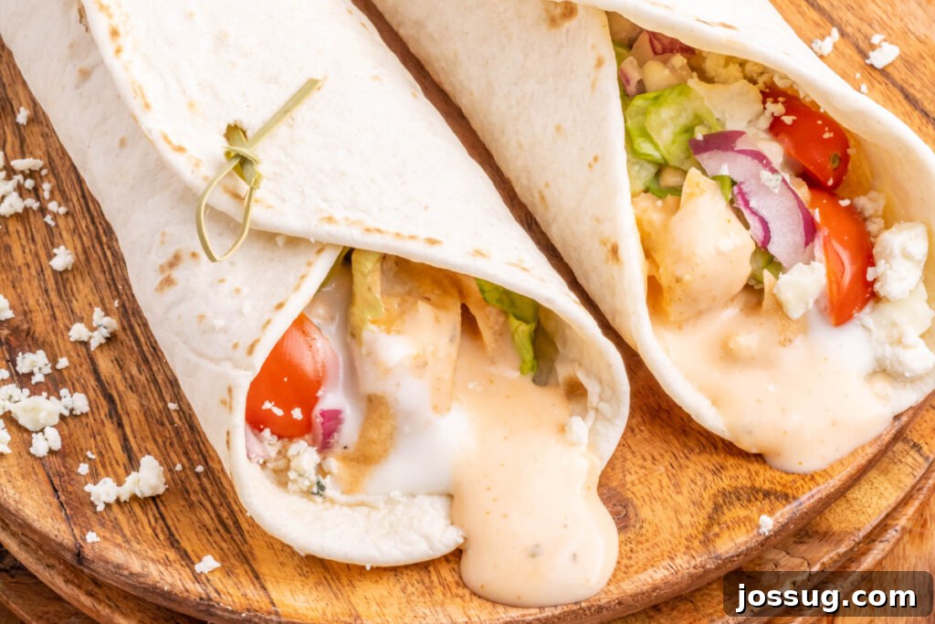 Spicy Buffalo Chicken Roll-Ups 6 two buffalo chicken wraps on wooden cutting board