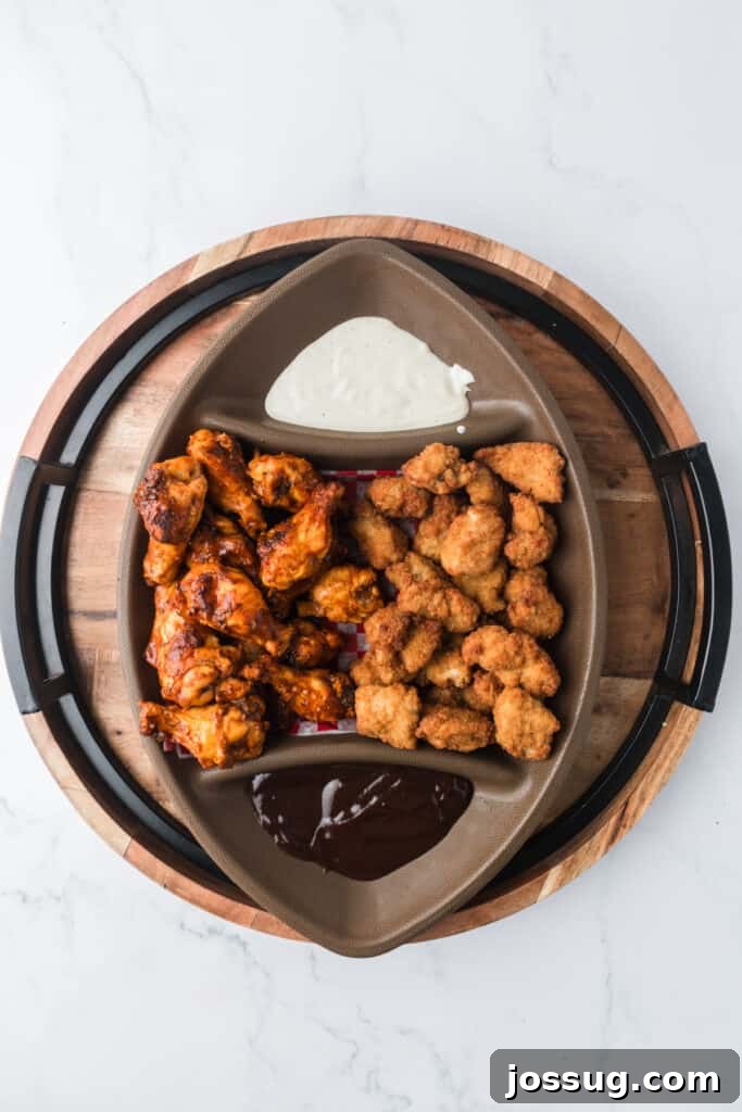 football platter filled with chicken and dipping sauces